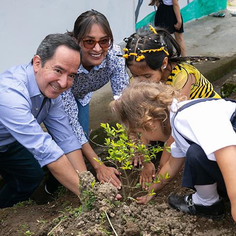 Leopoldo Báez y niñas plantan juntos en el espacio destinado a TINI.