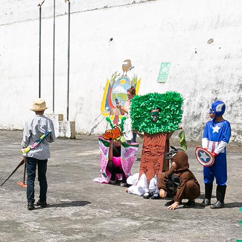 Niños y adultos participan en una representación teatral sobre el cuidado de la naturaleza.